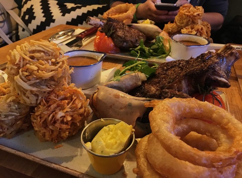 18oz ribeye, crab claw, homemade beer-battered onion rings, grilled tomato, Perl Las sauce and Covent Garden spiralized potatoes