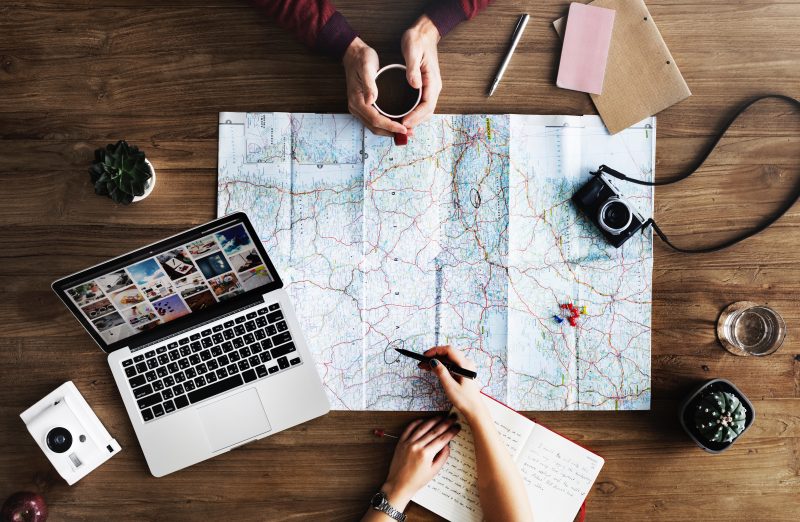 Map, laptop and camera set-up for travel planning