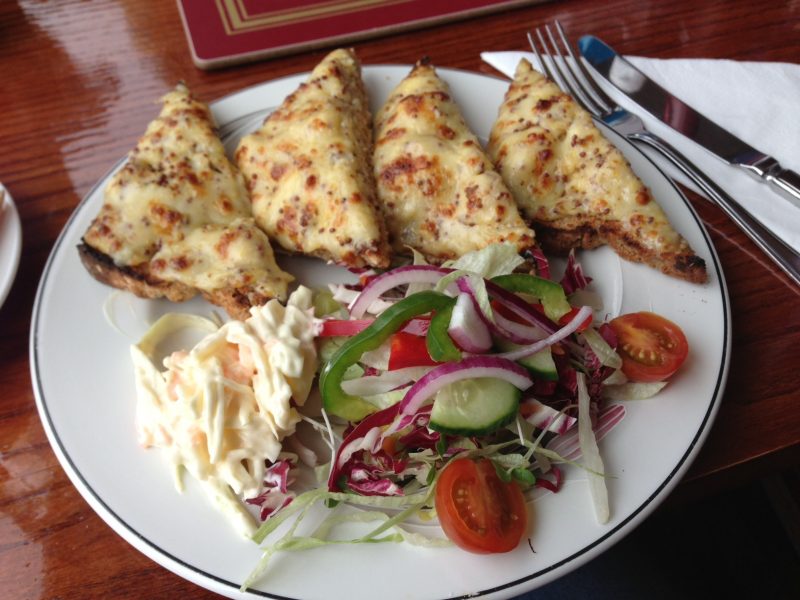 Welsh rarebit with wholegrain mustard, with coleslaw and side salad
