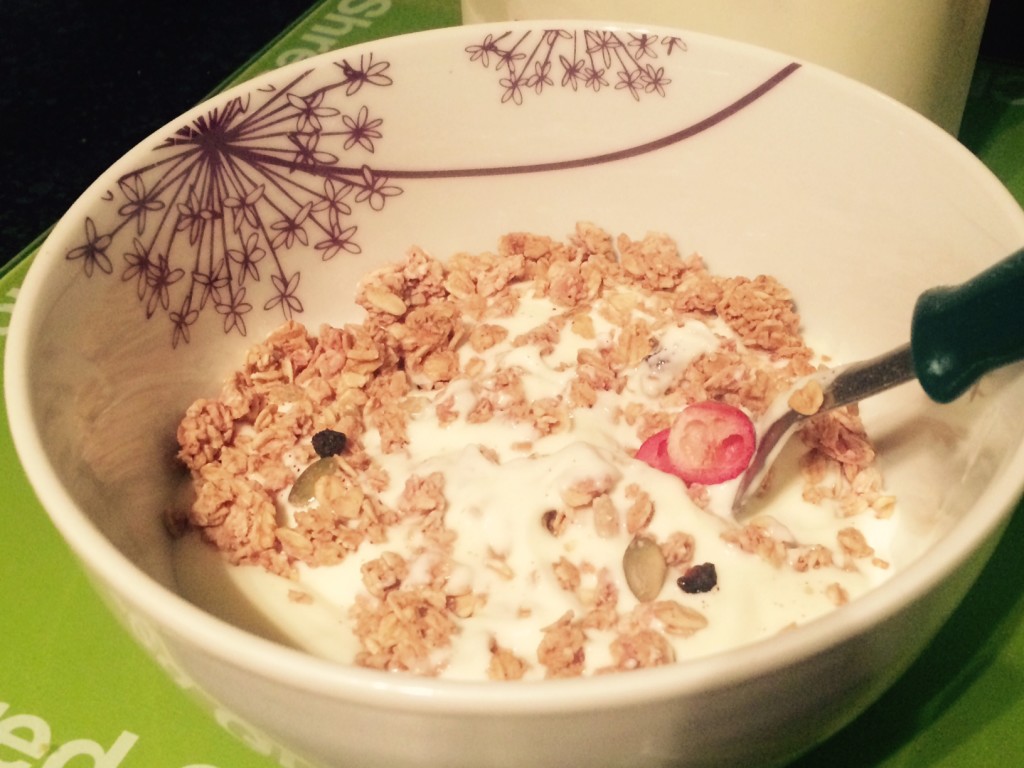A bowl of yoghurt topped with berry granola