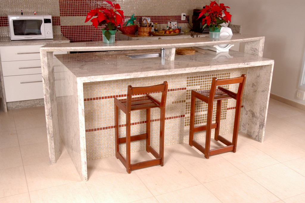 A modern, clean kitchen decorated with poinsiettas