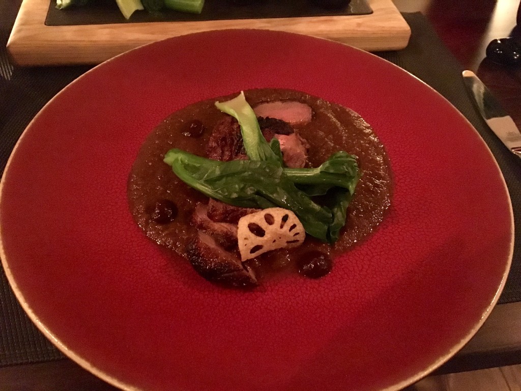 Duck tamarind curry with fresh greens and lotus root flower