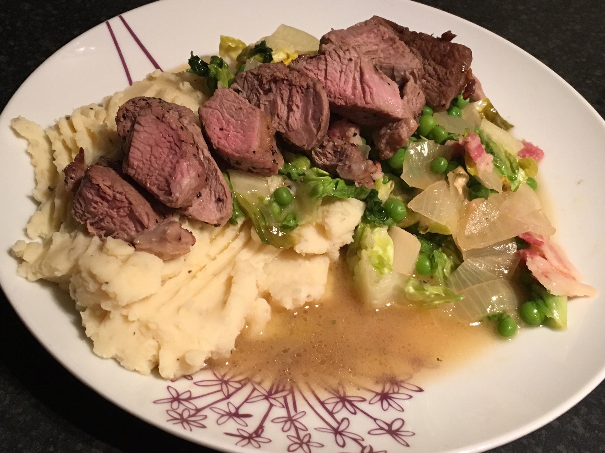 Lamb with peas, bacon, lettuce and mint on a bed of mashed potato