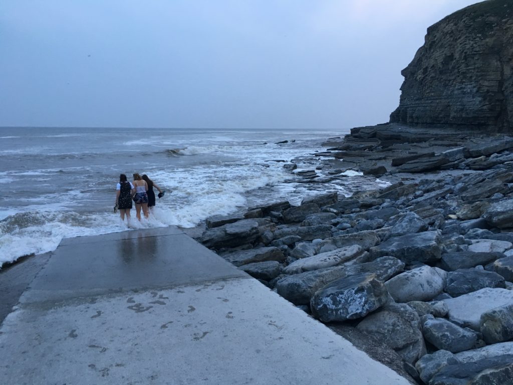 Paddling in the waves at Dunraven Bay