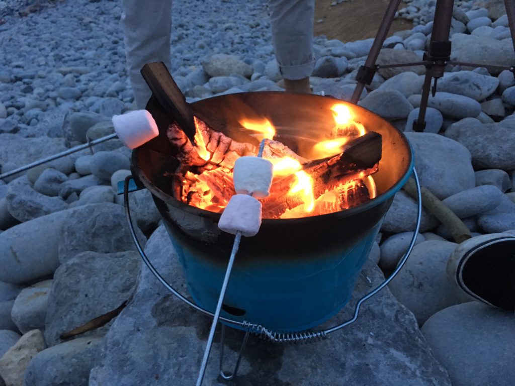 Roasting marshmallows on a beach fire