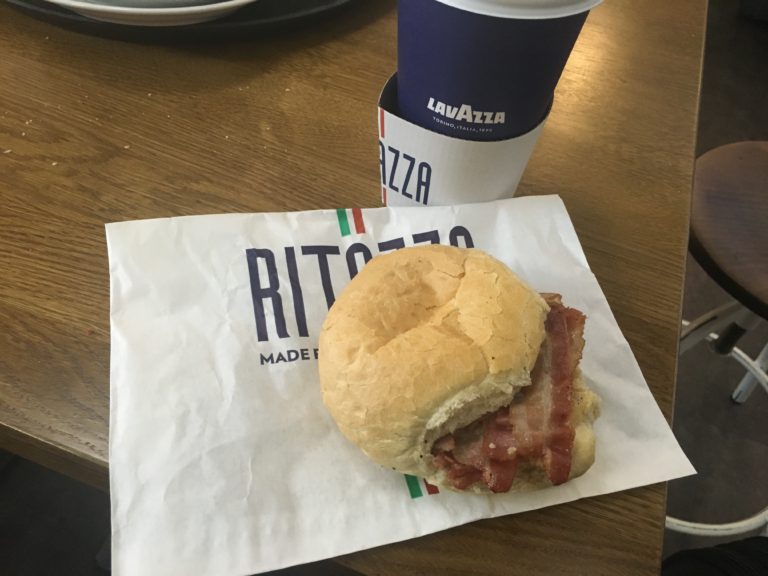 Bacon roll and coffee at Cafe Ritazza in Cardiff Airport