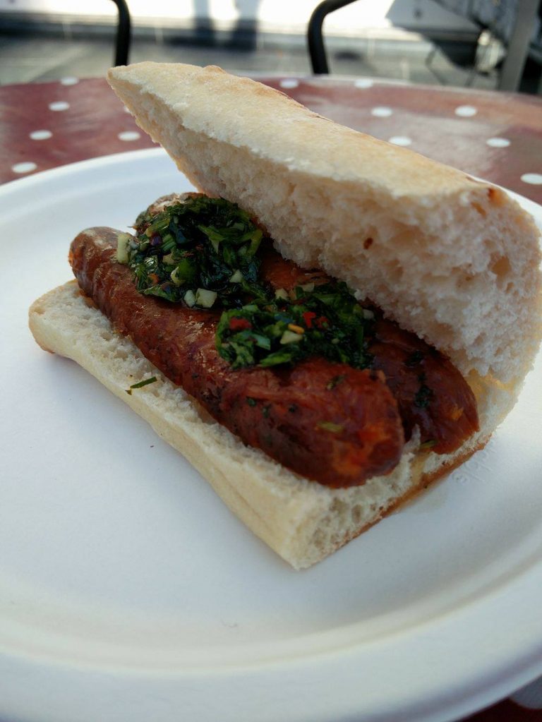 Sausage with chimichurri in ciabatta