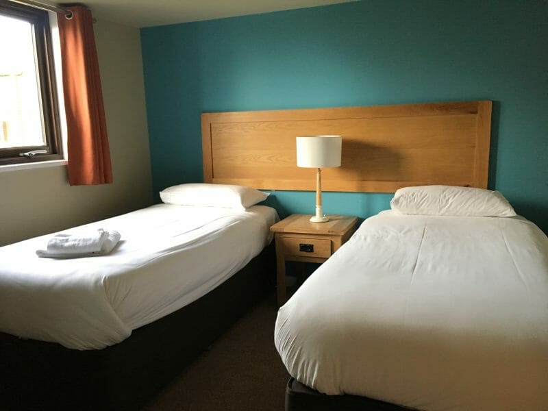 A twin bed set-up at Bluestone Wales