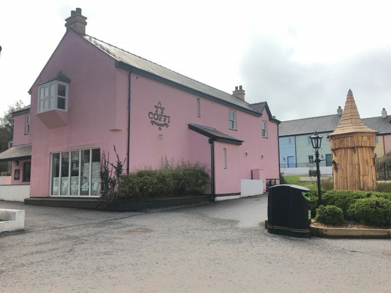 The exterior of Ty Coffi cafe at Bluestone Wales, painted a baby pink in colour