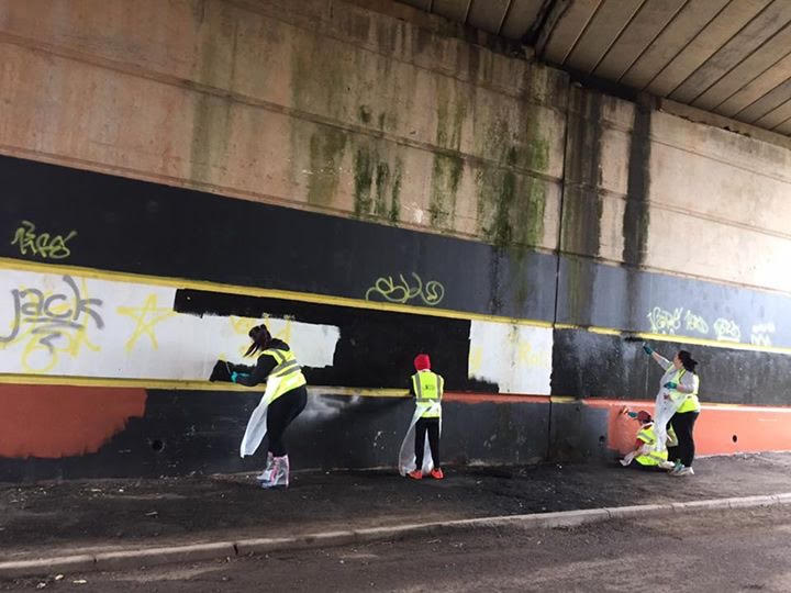 Painting over graffiti at Caerau Ely F.C in a litterpick organised by McDonald's Cardiff and Keep Wales Tidy