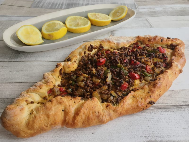 Turkish Kymani (mincemeat) pide served with fresh slices of lemon