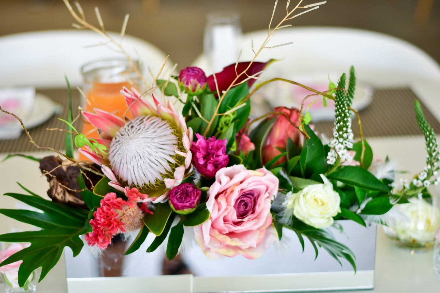 A flower arrangement on a table, ideal for a summer party