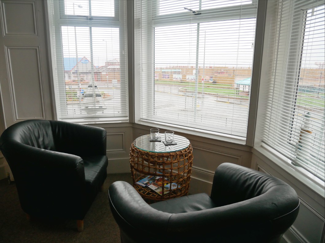 Leather armchairs overlooking Rhyl Beach and the Irish Sea