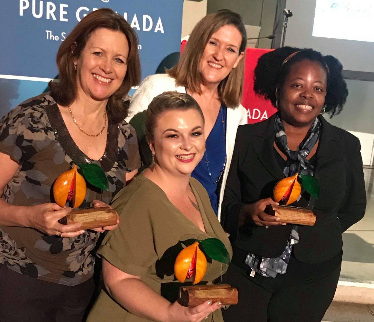 Heather Cowper, Ursula Petula Barzey and Kacie Morgan all receive awards at the Pure Grenada Awards 2018, pictured here with CEO, Patricia Maher
