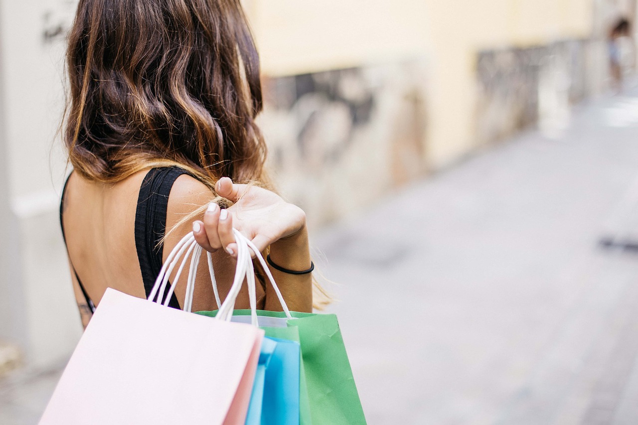 Woman carrying shopping bags over her shoulder