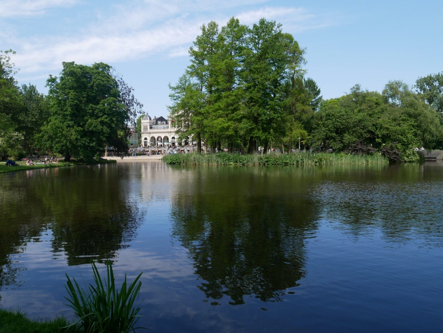 Vondelpark3 Bar and Restaurant peeking through the trees in Amsterdam Vondelpark