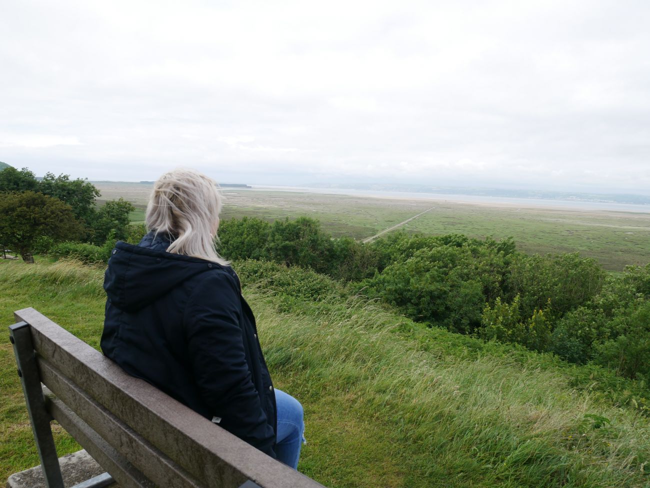 Girl sitting on a bench looking into the distance