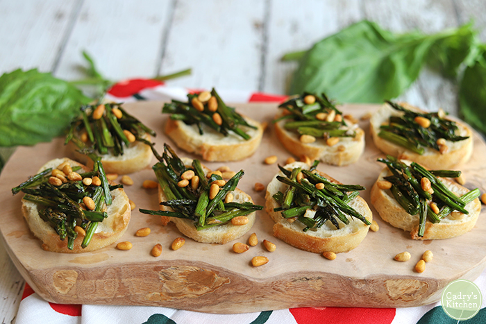 Bruschetta topped with asparagus and pine nuts