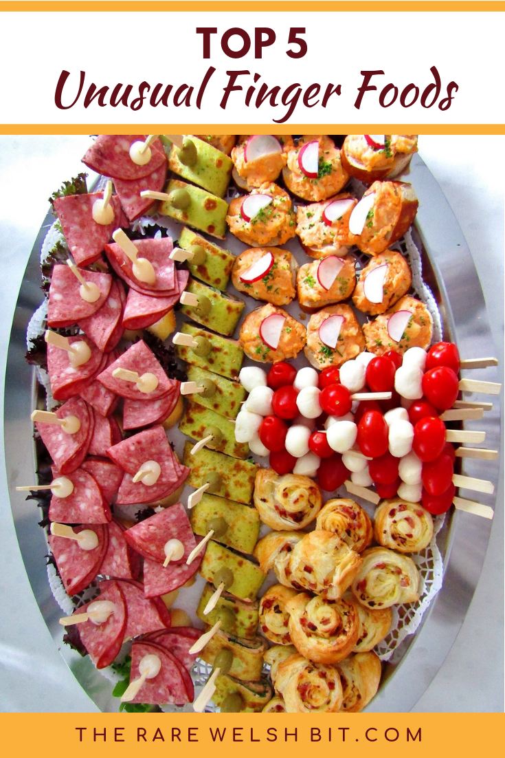 An oval platter filled with tasty tapas treats and finger foods ideal for a garden party menu