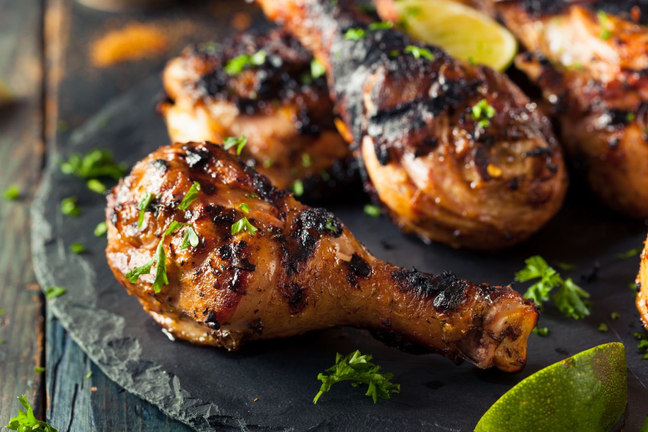 Crispy, grilled jerk chicken cooked over a barbecue