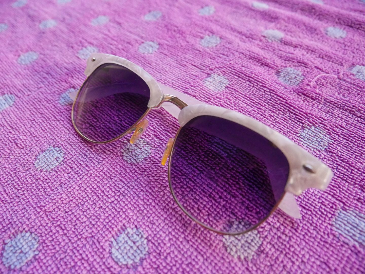 These fashionable white sunglasses are a must for any beach packing list.