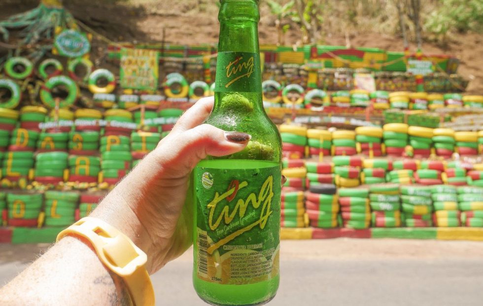 Holding a bottle of Ting grapefruit crush at Charlie's Bar in Grenada