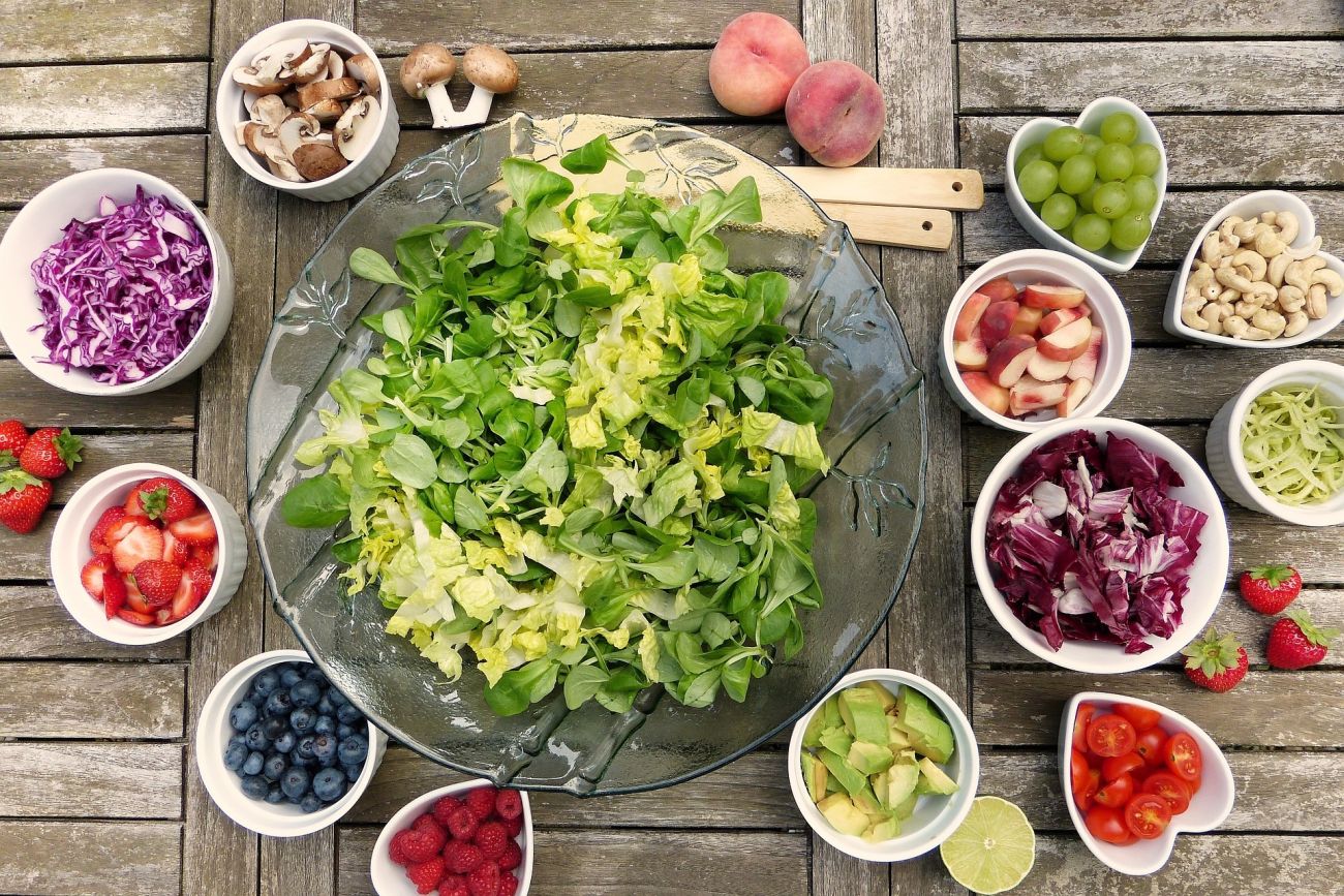A flat lay of colourful salad veg and berries.