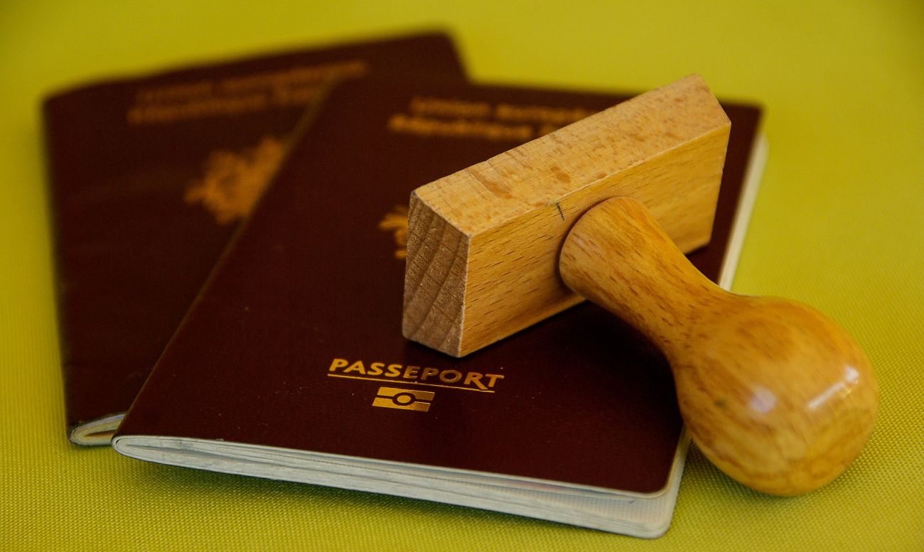 Two passports with a wooden rubber stamp