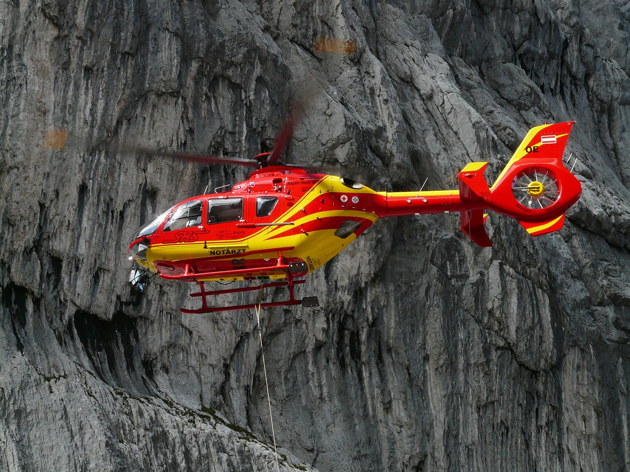 A red rescue helicopter used for emergency care and sometimes, repatriation - one of the key travel insurance benefits.