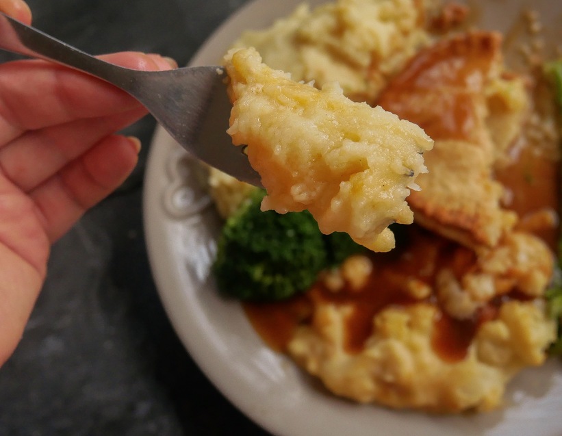 Cheese and onion pie filling shown on a fork