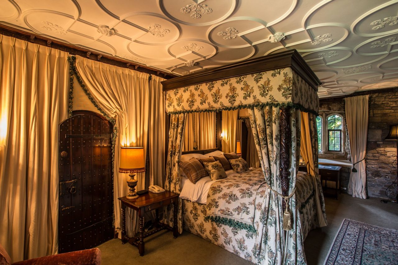 Thornbury Castle, Bristol is one of the most quirky places to stay in the UK. This picture shows one of the bedchambers, complete with four-poster bed.