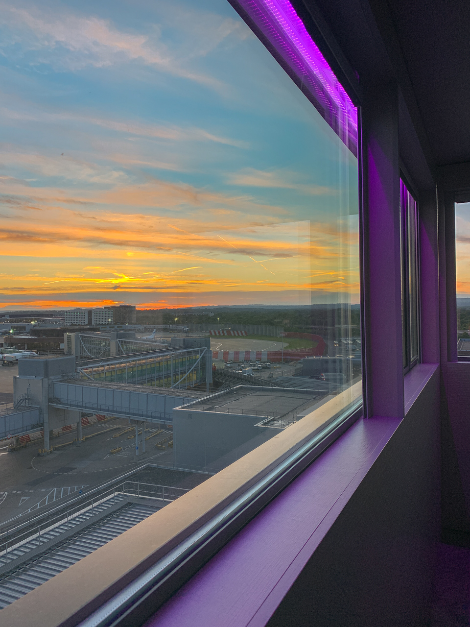 Sunset through the runway view window at Bloc Hotel Gatwick