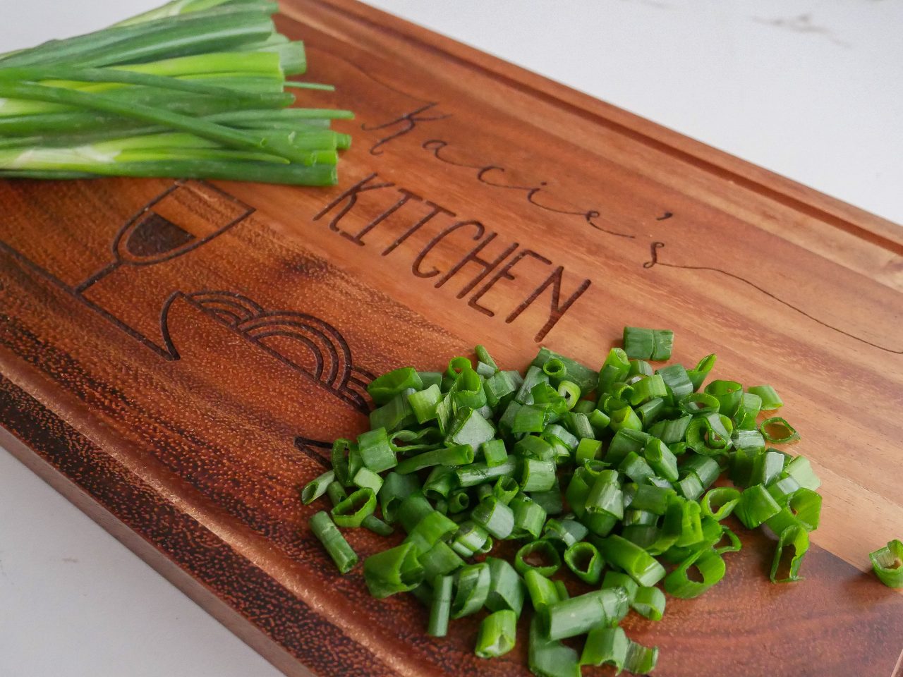 Chopping spring onions on a personalised chopping board