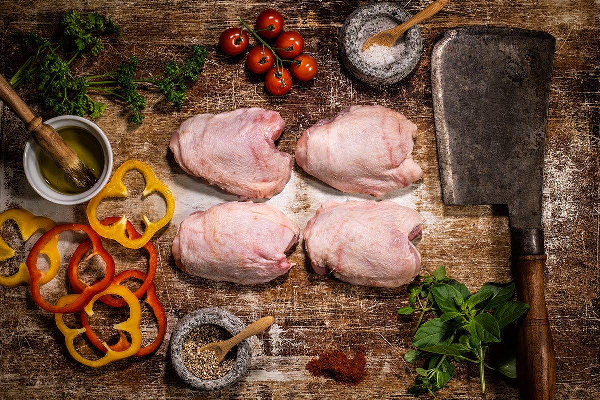 Preparing poultry on a board