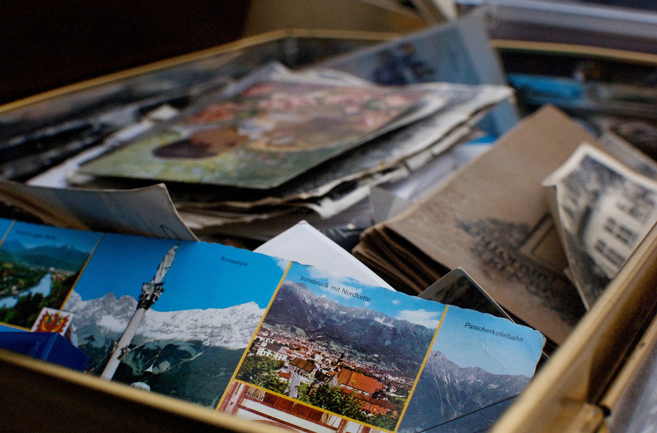A box of old photos and postcards for moving home.