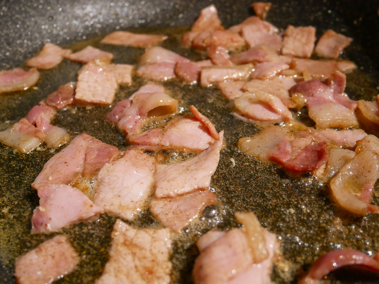 Bacon sizzling in frying pan