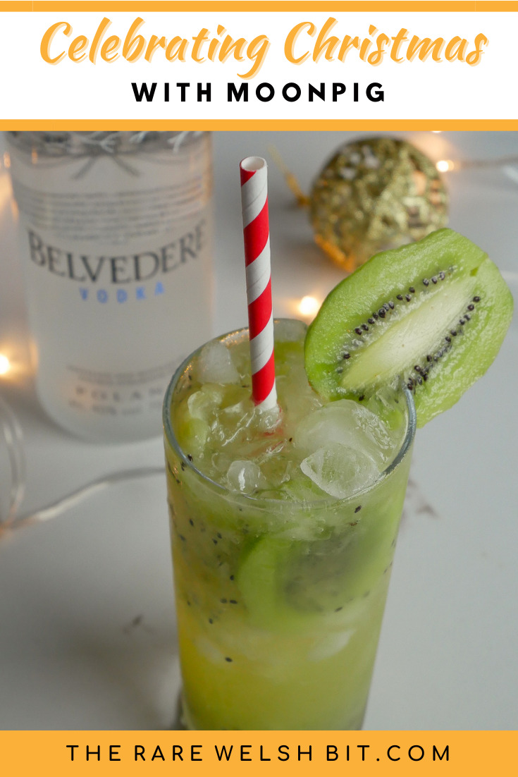 Kiwi Collins with a bottle of Belvedere vodka behind it
