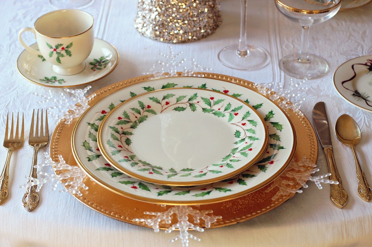 A table place setting laid for Christmas dinner, with festive crockery