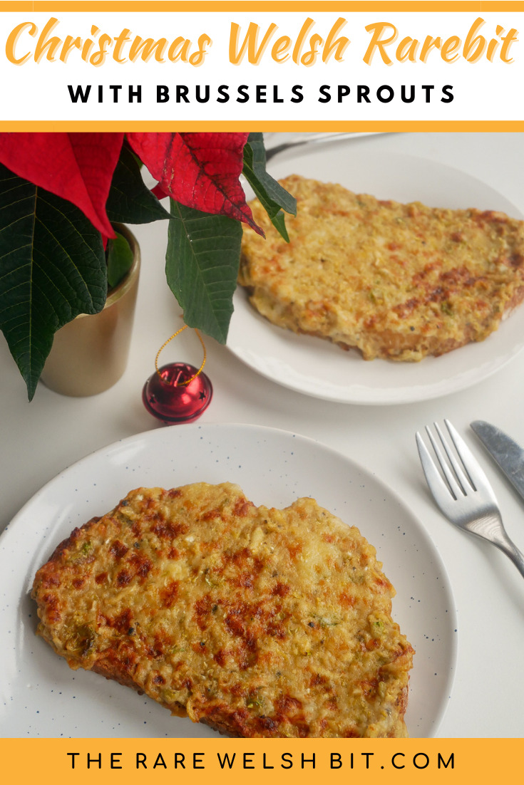 Traditional Welsh rarebit with Brussels sprouts, next to a Christmas poinsettia and a Christmas bauble
