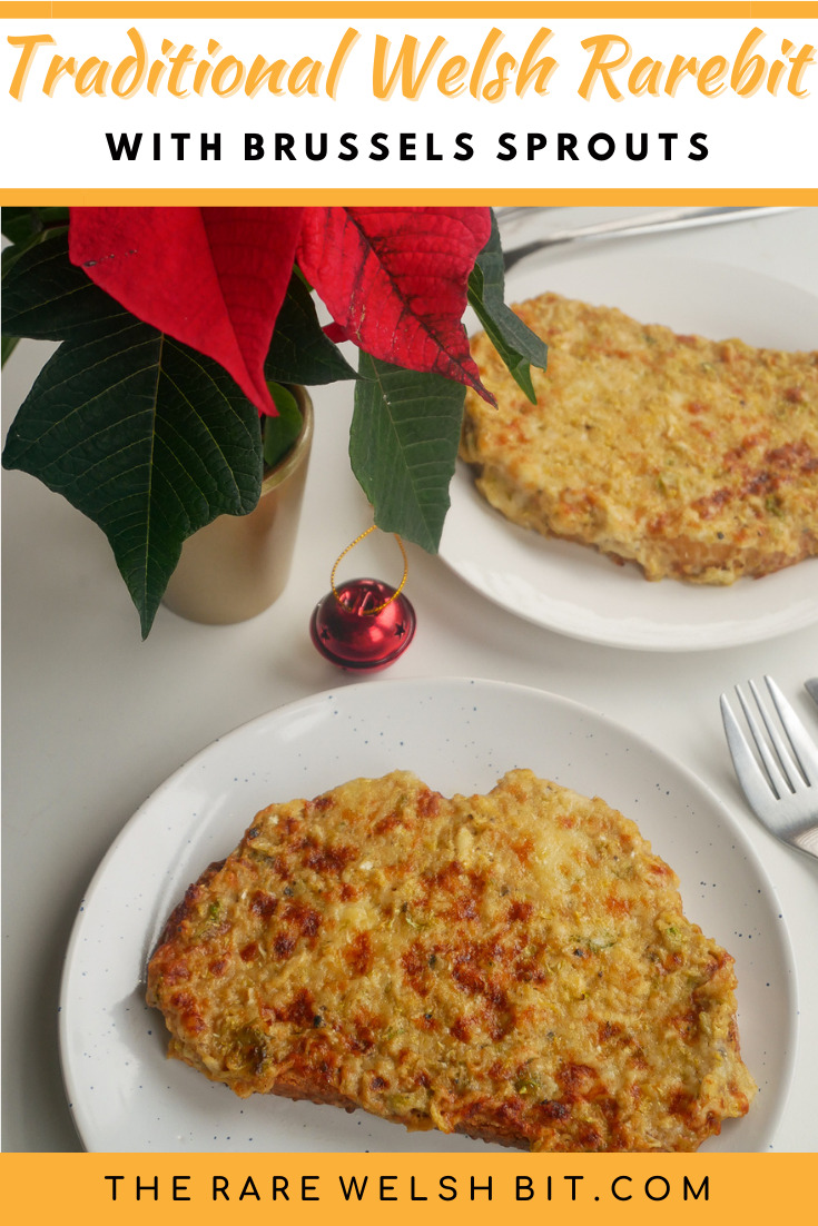 Traditional Welsh rarebit with Brussels sprouts, next to a Christmas poinsettia and a Christmas bauble