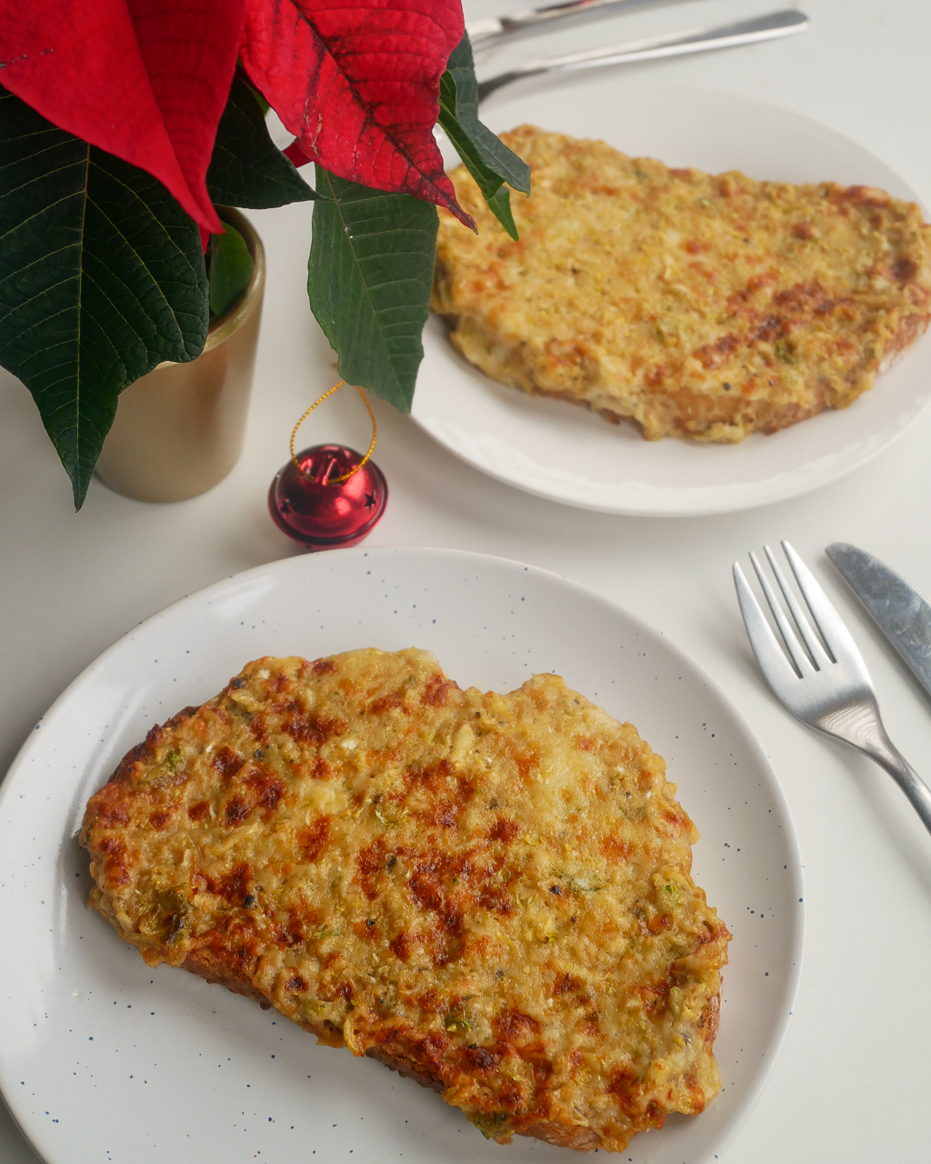 Christmas Brussels sprouts Welsh rarebit next to a red bauble and mini ponsietta