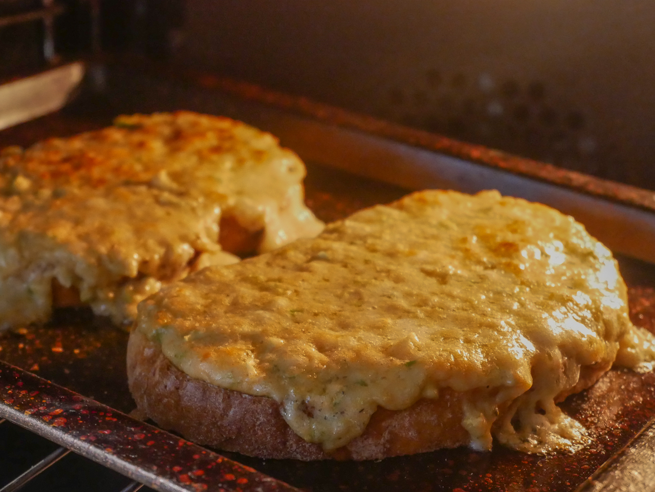 Welsh rarebit bubbling underneath the grill, made using Christmas Brussels sprouts