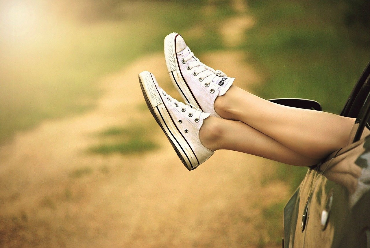 Ladies' legs hanging out of a car door