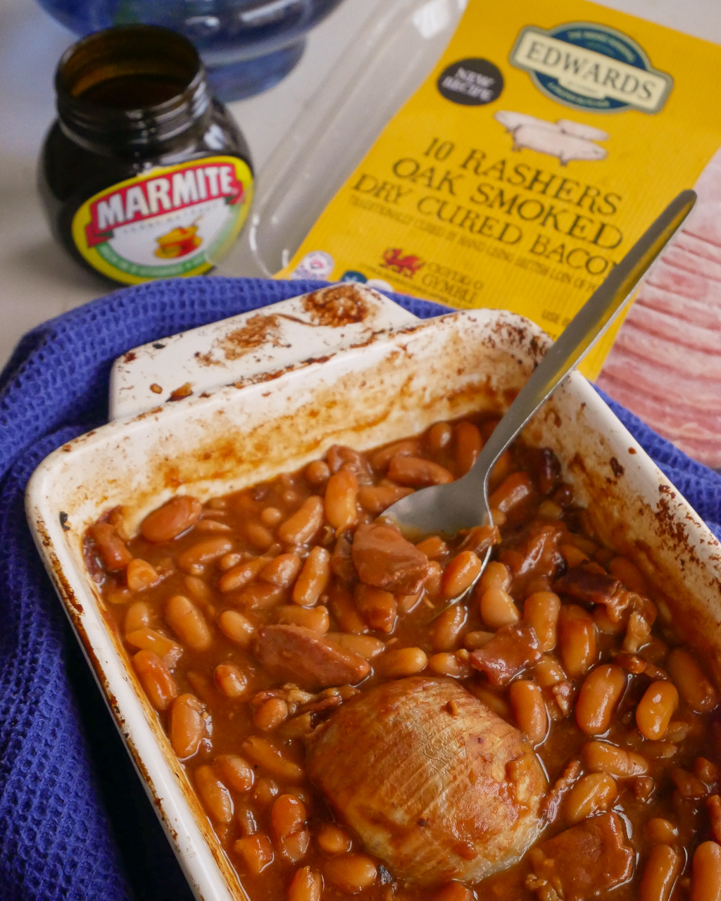 Homemade baked beans with Marmite and bacon, with Edwards of Conwy bacon in the background