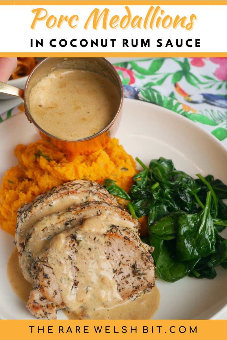 A mini saucepan pouring sauce over porc medallions with spinach and sweet potato mash