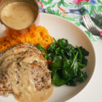 Pouring sauce over pork medallions from a mini saucepan
