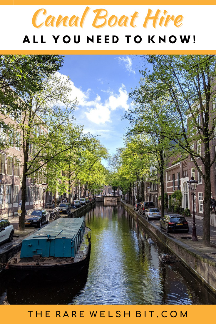 A narrowboat sailing down an Amsterdam canal