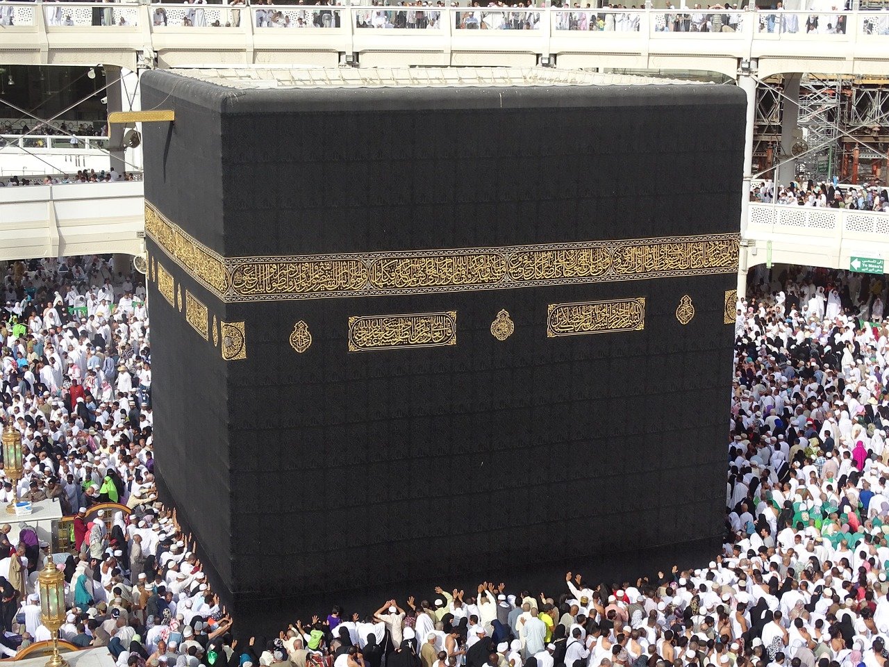 The cube-like Kaaba in the centre of the Great Mosque of Mecca, surrounded by Muslims