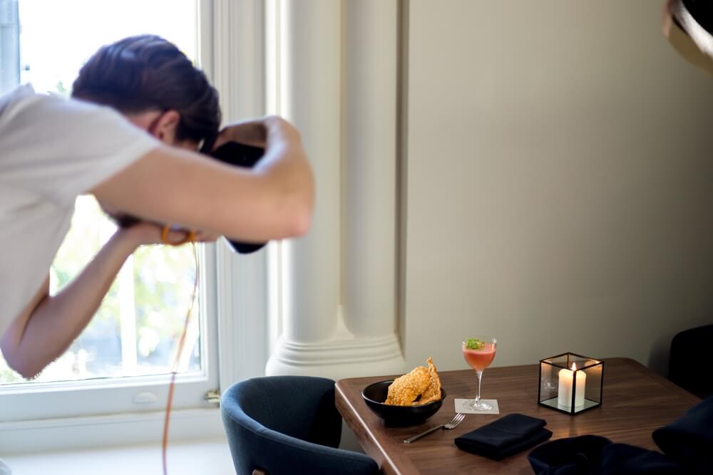 A man photographing food on a table