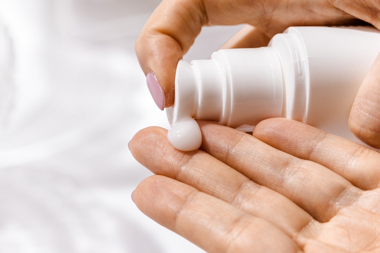Squirting moisturiser onto a hand